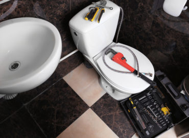 Plumber's tools on toilet at home